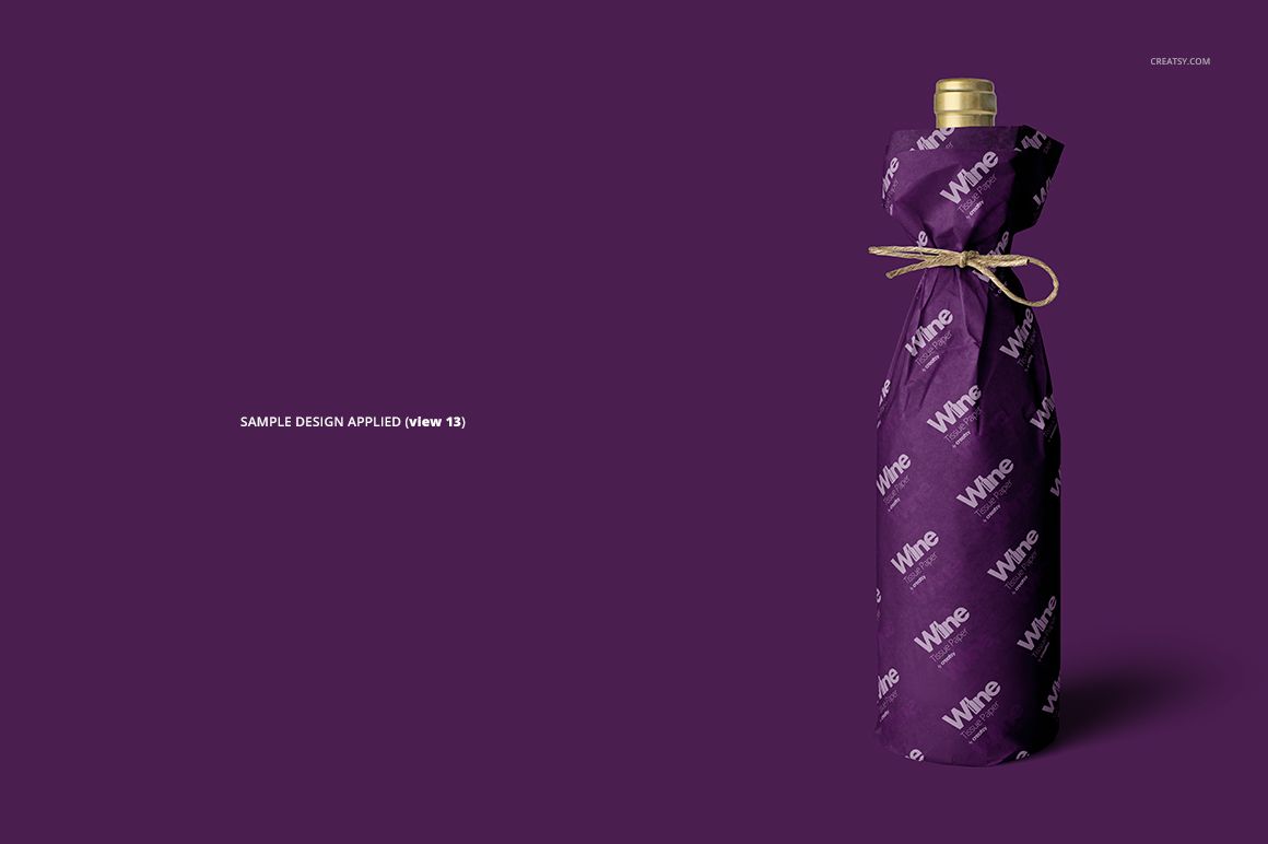 Mockup of a wine bottle covered in purple wrapping tissue paper featuring white lettering, shown from the front.