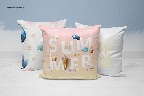 Set of three decorative pillows featuring pastel seashell prints, shown in a PSD mockup on a light floor background.