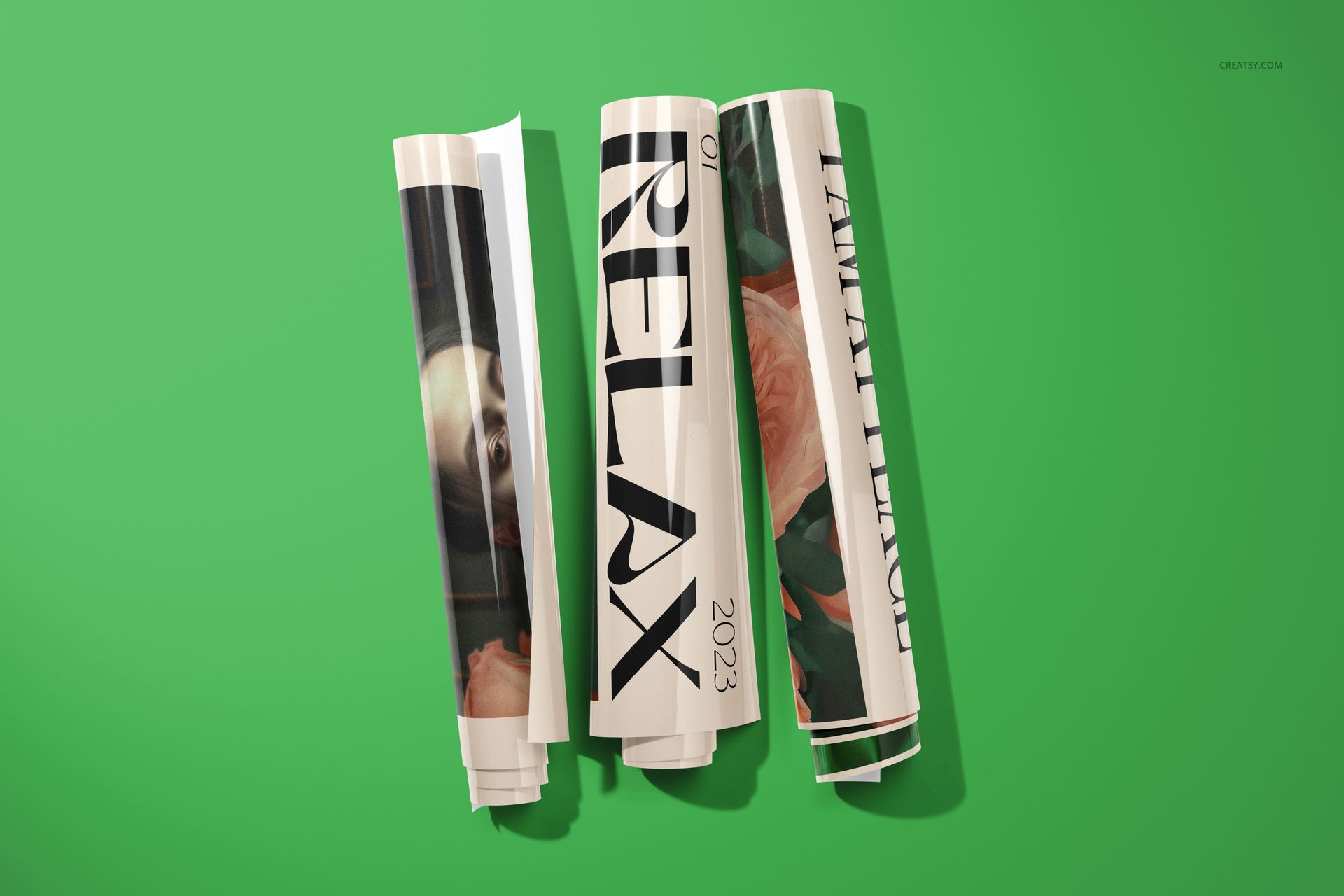 Rolled poster mockups with glossy finish, featuring large typography and partial floral designs on a green surface.