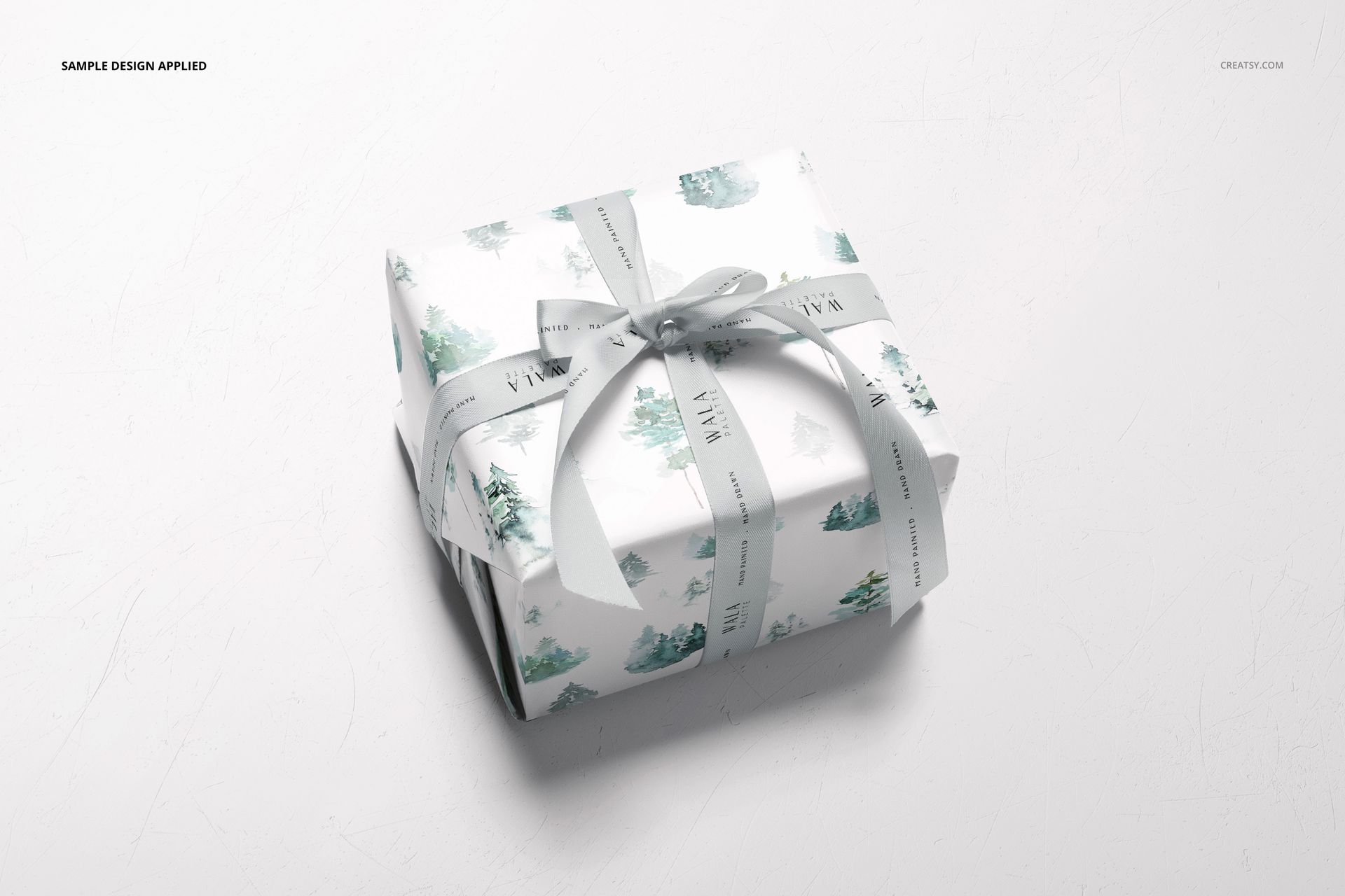 Gift wrapping paper mockup featuring a rectangular box with soft blue and green designs, viewed from above.