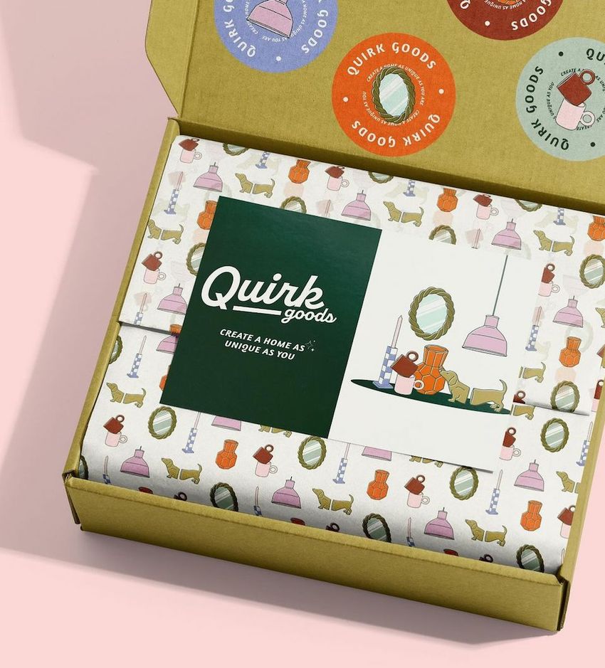 Stationery mockup featuring an open box with patterned tissue paper, a green card, and a small illustrated print inside.