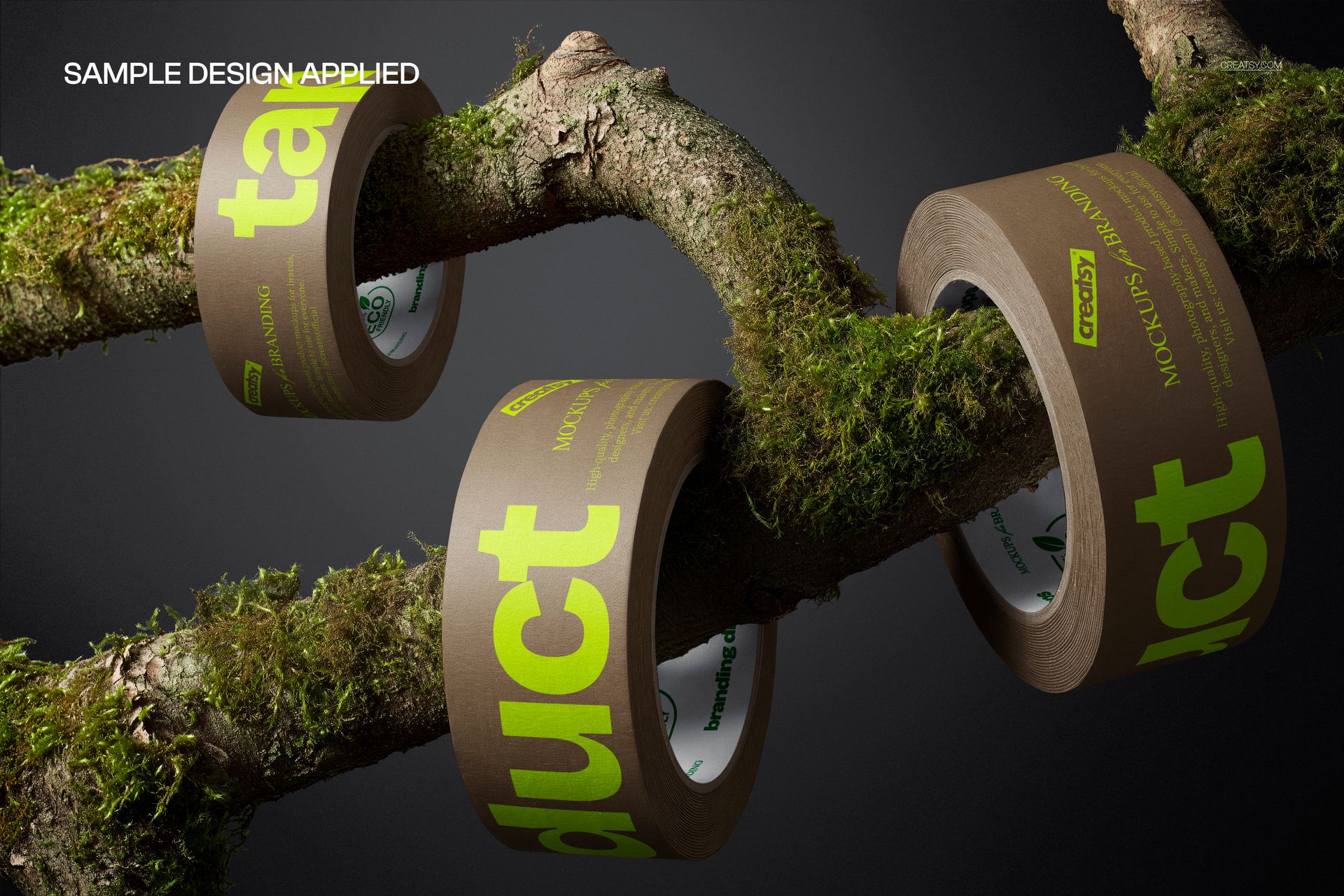 Adhesive tape mockup featuring brown rolls with bold green lettering arranged on a moss-covered tree branch.