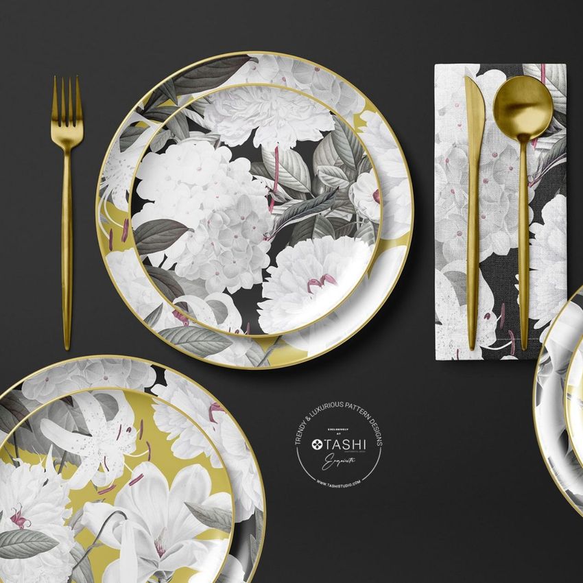 Placemat napkin plate mockup featuring floral-patterned plates and napkin with gold cutlery on a dark background.