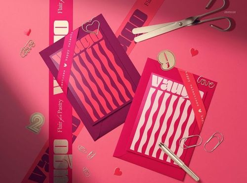 Two Valentine’s Day envelope mockups in red and purple tones with wavy patterned cards on a pink surface.