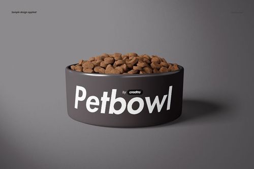 Round pet bowl mockup with large white lettering, filled with dry pet food, displayed on a plain gray backdrop.