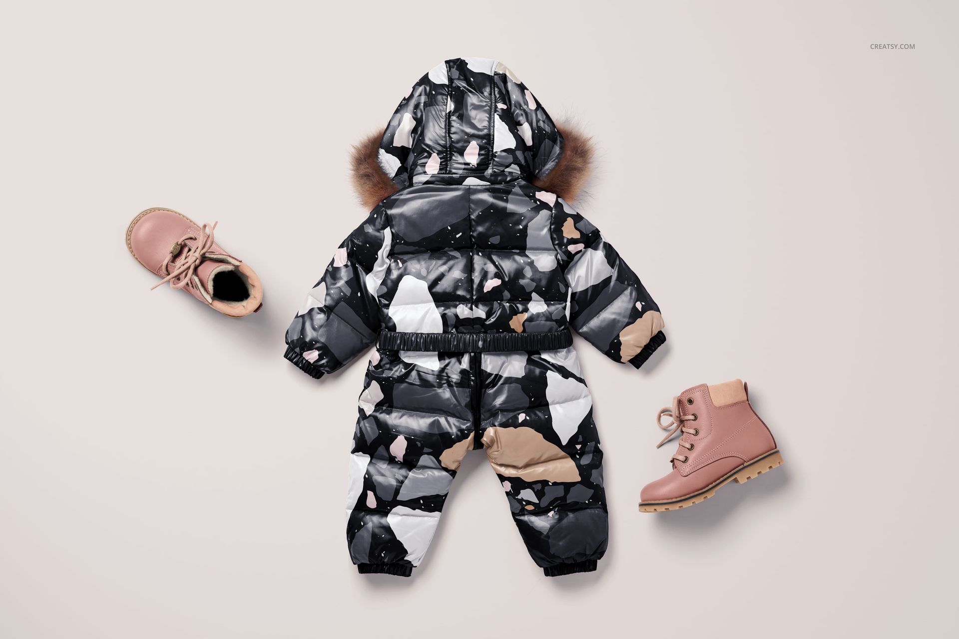 Kids snow suit mockup featuring a fur-trimmed hood and geometric print, shown with pink boots on a neutral background.