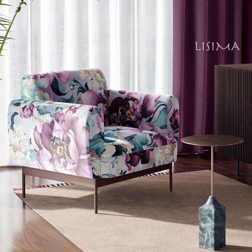 Mid-century modern interior mockup featuring a floral armchair, round side table, and purple curtains near a window.