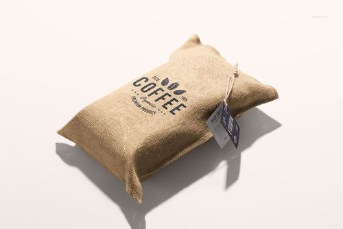 Coffee bag mockup featuring a textured brown sack with black lettering and a paper tag, displayed at a slight angle.