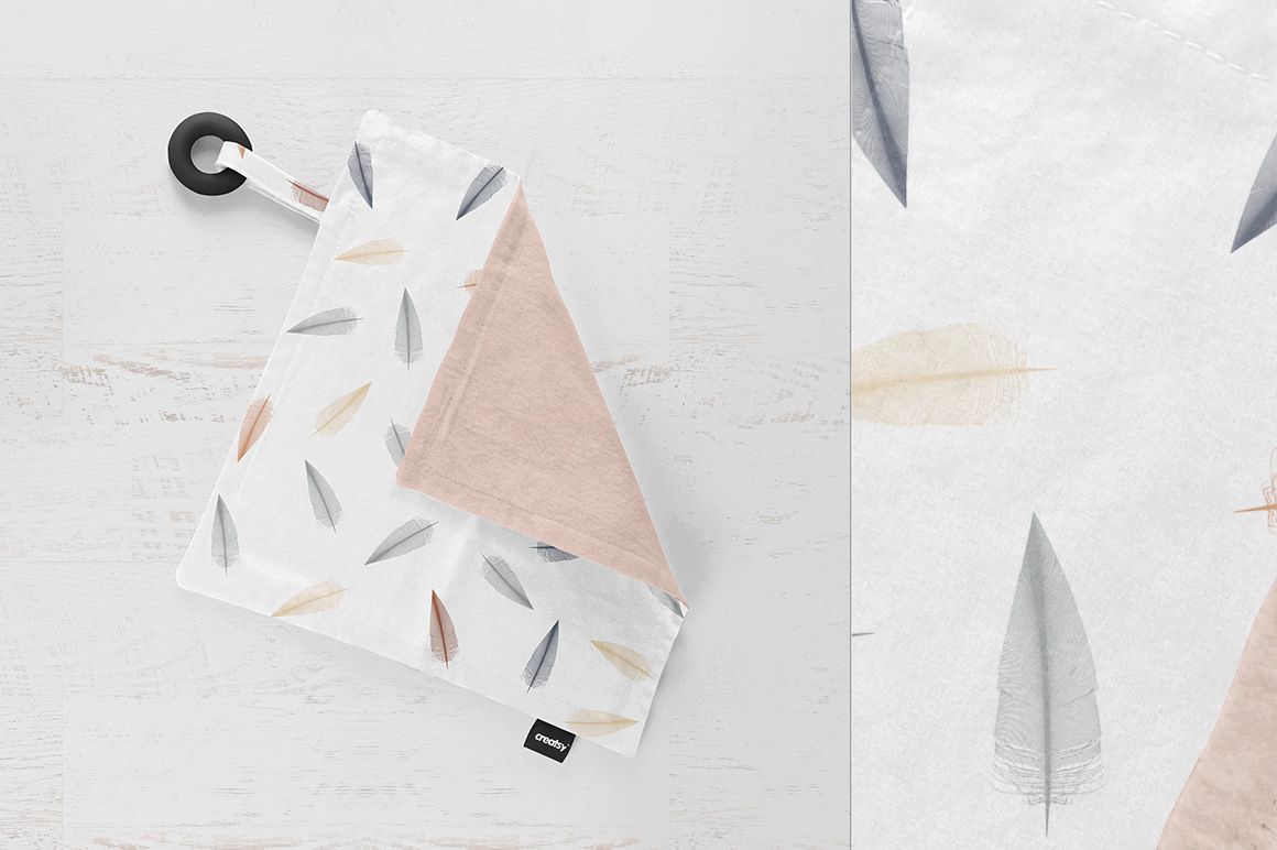 PSD mockup of a kids' teething blanket featuring soft feather prints, removable label, and a black teething ring.