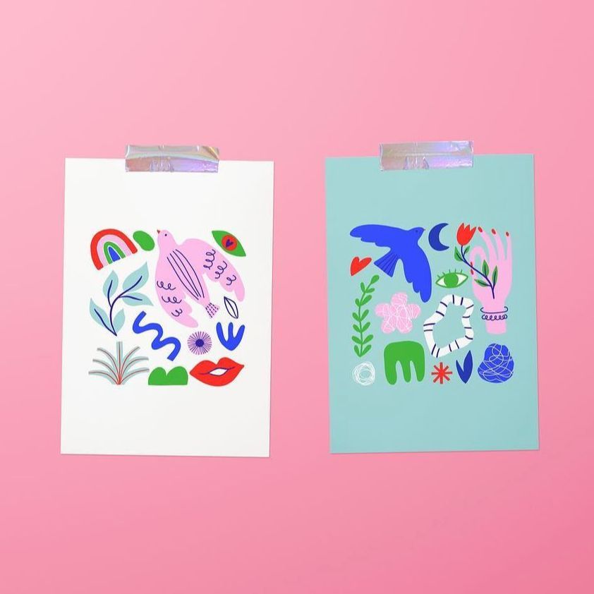 Two paper valentines card mockups with colorful abstract illustrations, taped to a pink background, one white and one teal.