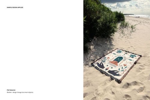 Mockup of patterned throw blanket with dark fringe displayed on a beach, surrounded by dunes and greenery.