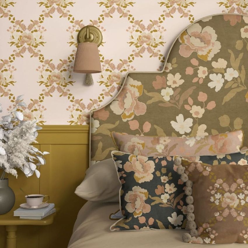 Bedroom mockup featuring a floral patterned headboard, pillows, and wallpaper in muted pink, beige, and olive tones.