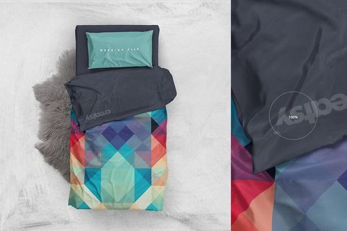 Top view of a single bed bedding mockup featuring a multicolored geometric duvet and solid dark blanket.