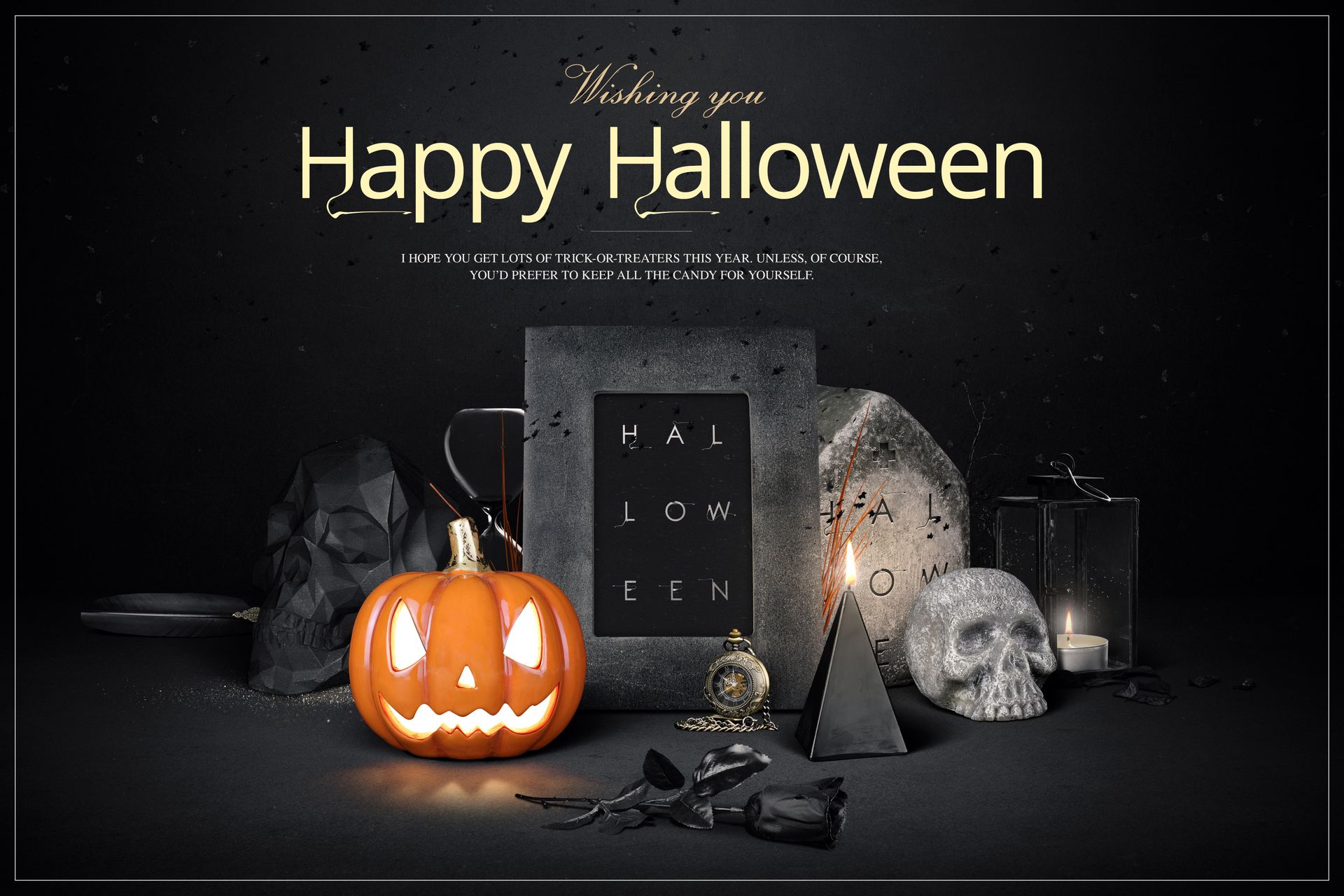 Front view of a Halloween-themed mockup featuring a jack-o'-lantern, skull, candle, and decorative props in a dark setting.
