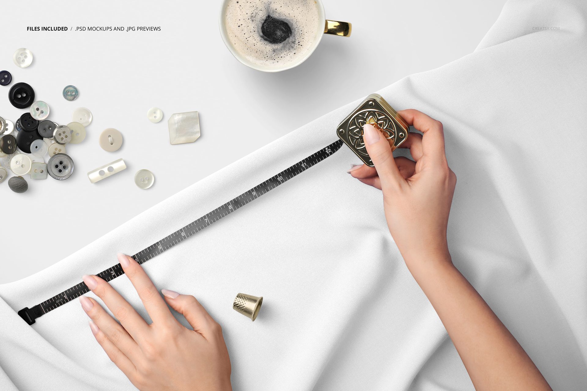 White cloth being measured with a sartorial meter, sewing accessories and a gold-rimmed coffee mug on the table, PSD mockup.