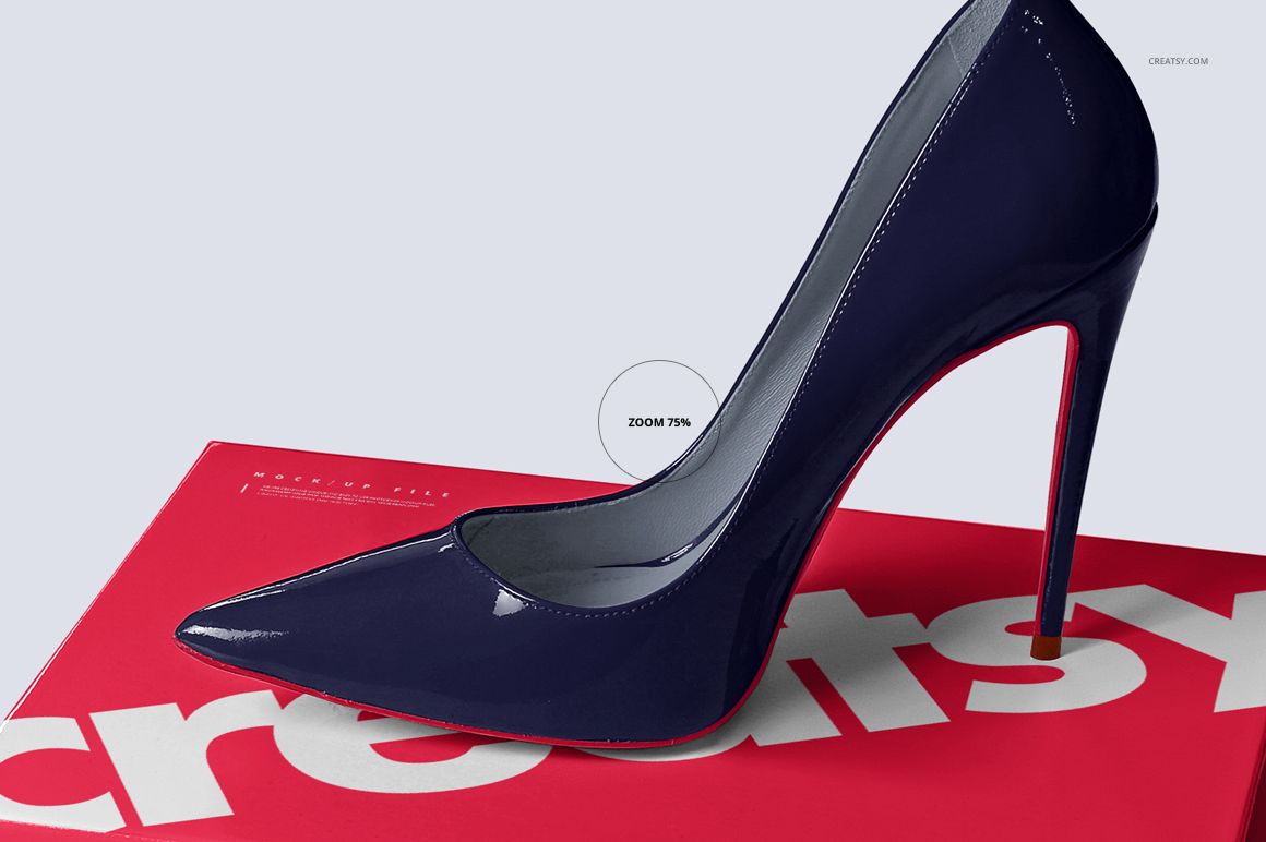 PSD mockup showing a shiny navy high heel resting on a red box with white text, captured from a close side perspective.