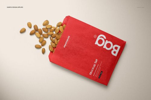 Red sandwich or snack paper bag mockup with almonds spilling out, shown from a top angle on a neutral background.