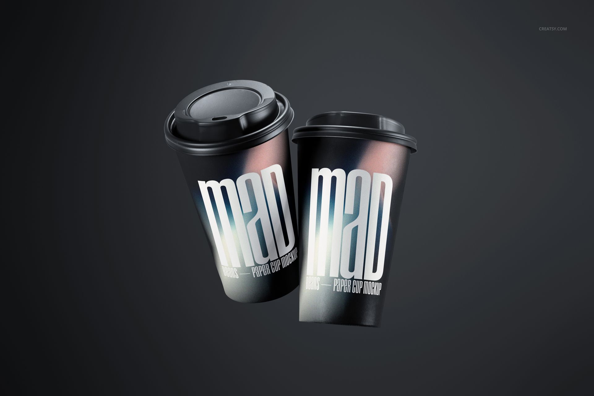 PSD mockup of two paper cups with black lids, metallic gradient surface, and prominent white typography on each.