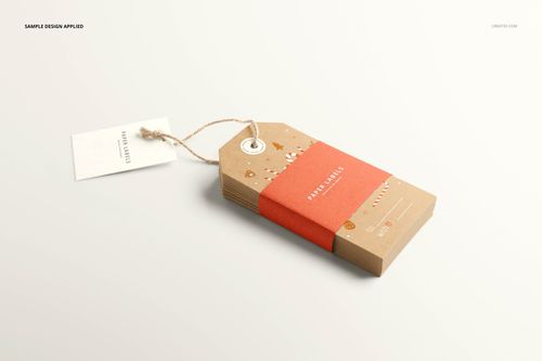 Stack of rectangular paper labels with a string, featuring a festive design and red band, shown in a PSD mockup.