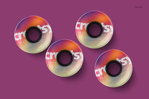 PSD mockup showing four penny skateboard wheels with black centers and vibrant gradient colors, viewed from above.