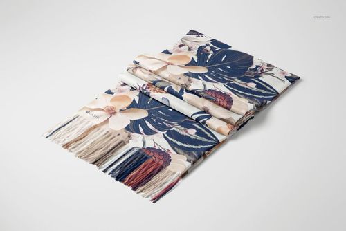 Folded cashmere scarf with a floral and leaf pattern in navy, beige, and red, shown on a white surface.