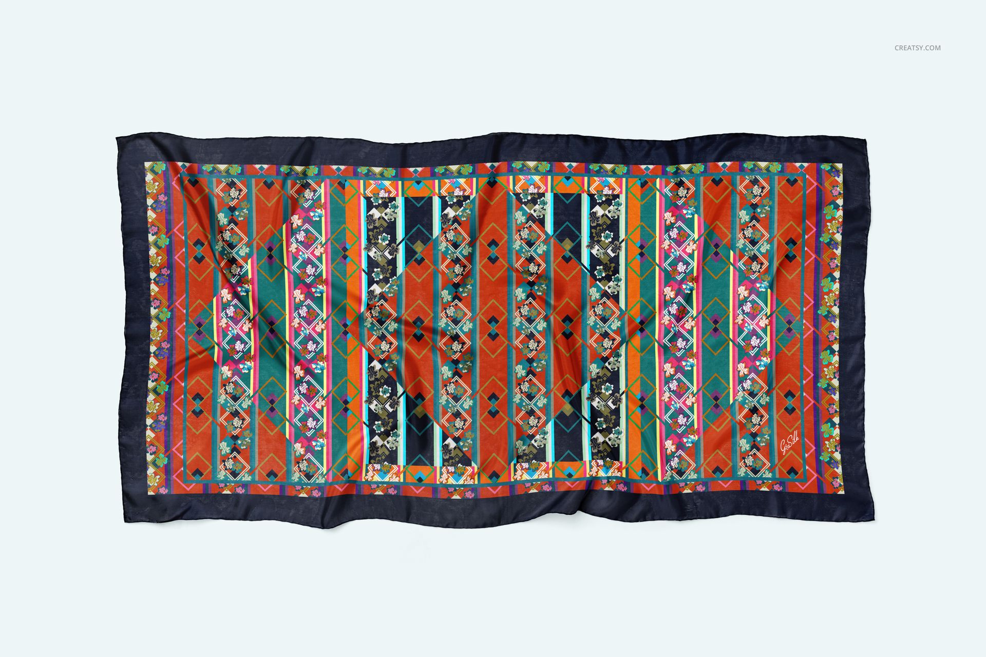 Vibrant silk scarf mockup featuring a multicolored geometric design and hand-rolled edges, viewed from above.