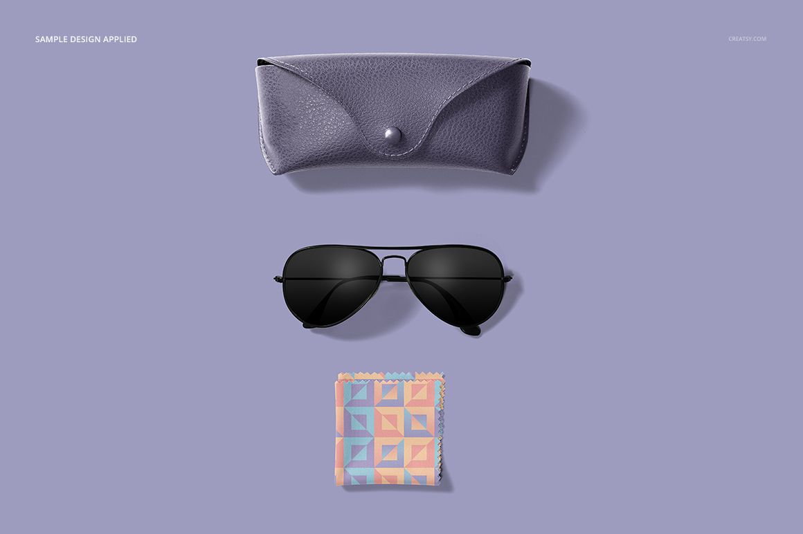 Top view of a mockup set featuring a pastel patterned microfiber cloth, aviator sunglasses, and a purple glasses case.
