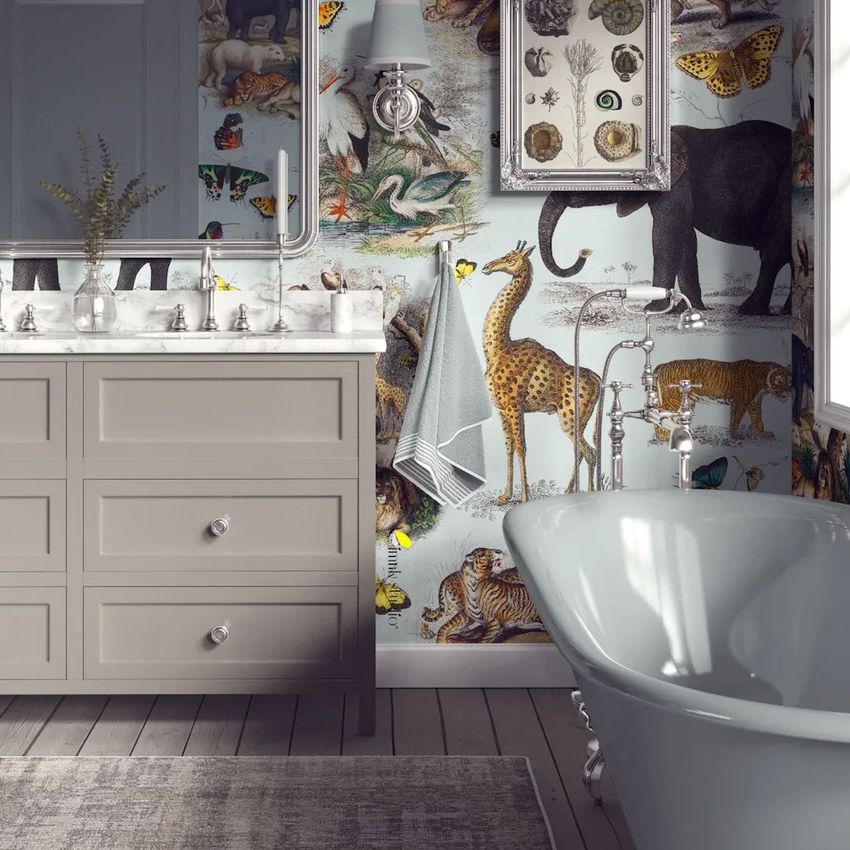 Victorian bathroom wallpaper mockup showing a clawfoot bathtub, gray vanity with marble countertop, and animal-themed wallpaper.