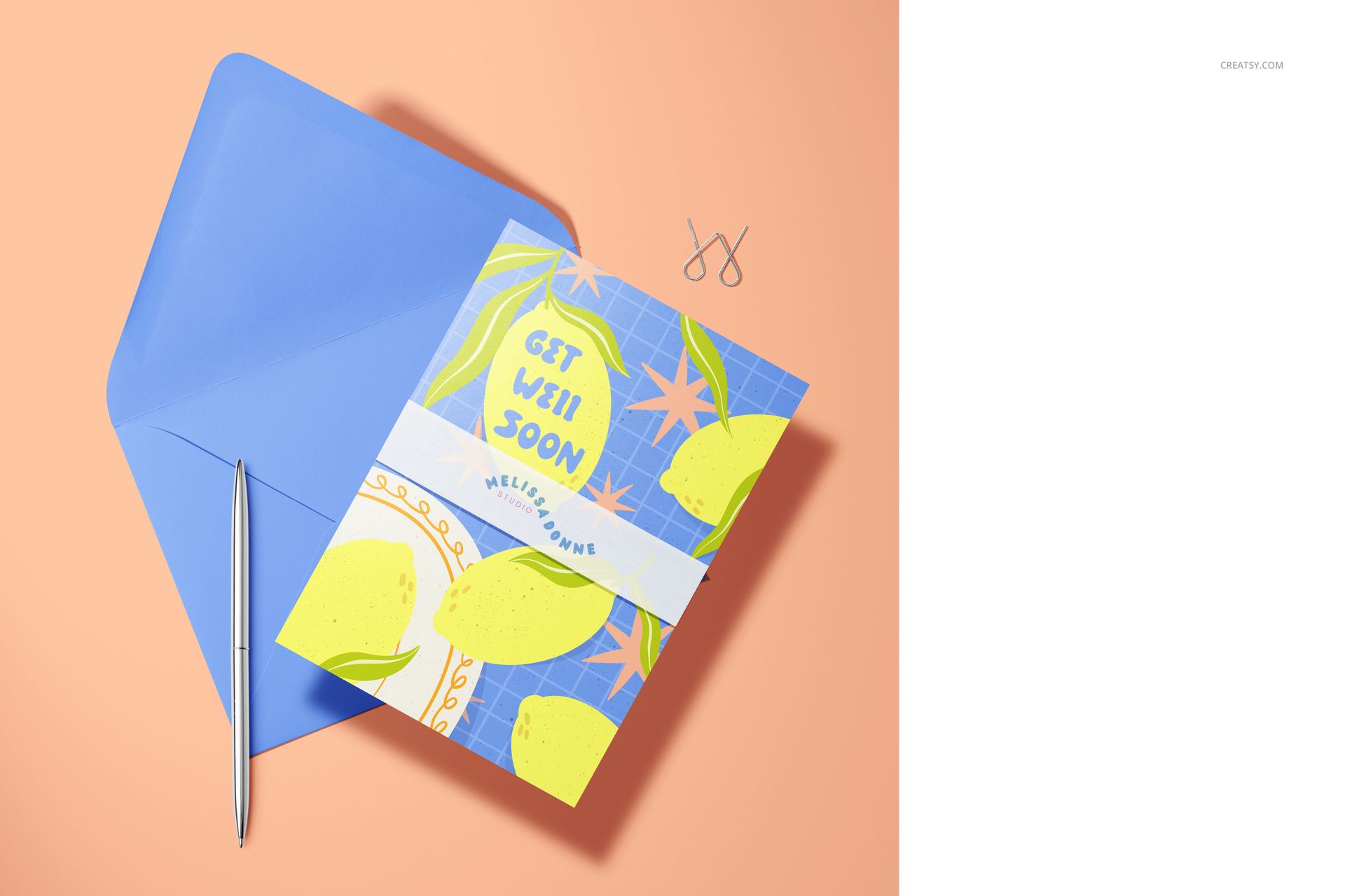 Front view of a vibrant A5 card mockup featuring lemons and leaves, next to a matching blue envelope and pen.