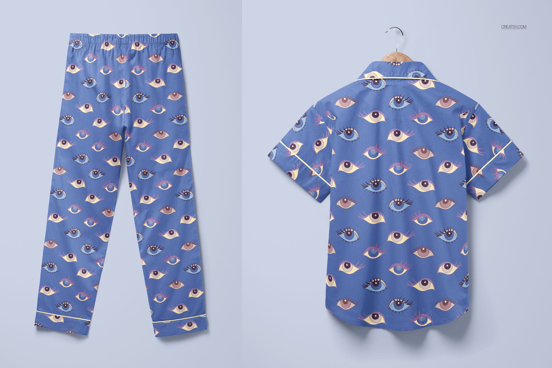PSD mockup of sleepwear set with blue short-sleeve shirt and pants, both decorated with repeating eye motifs, displayed flat.