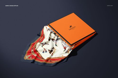 Silk scarf box mockup featuring an orange lid and black border, scarf with horse rider pattern partially displayed.