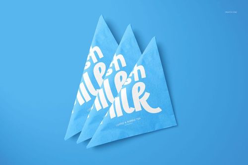 PSD mockup showing three folded napkins with a graphic white text pattern on a vibrant blue background.
