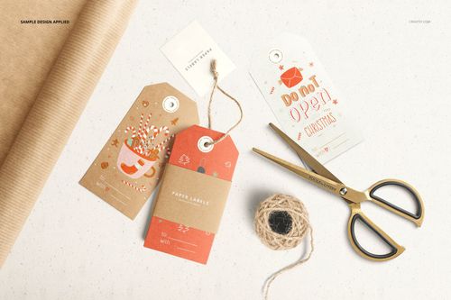 Paper labels mockup set featuring tags in various shapes and colors, presented with crafting tools and string.