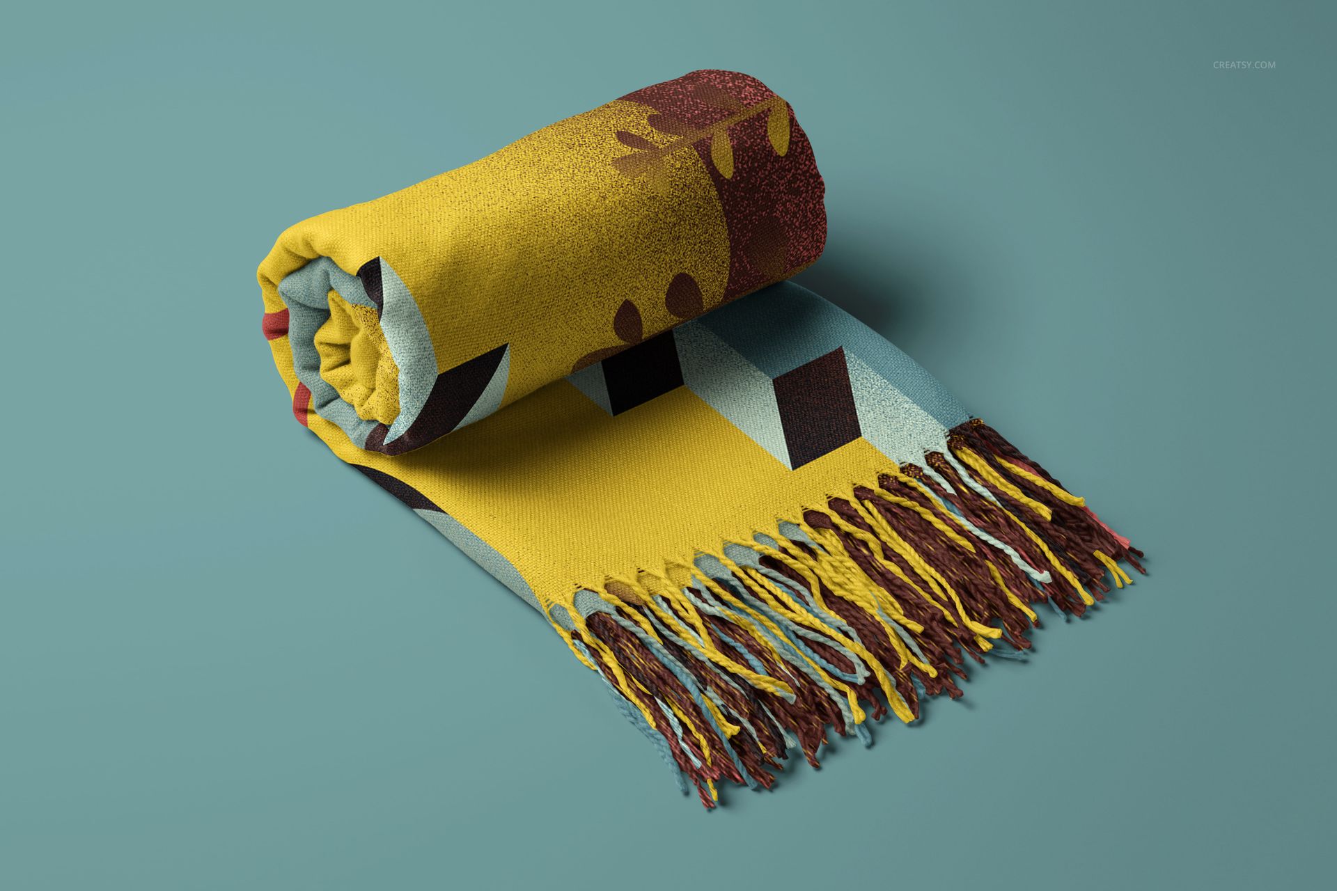 Yellow and brown tassel fringe blanket mockup, rolled up with geometric design, displayed on a teal background.