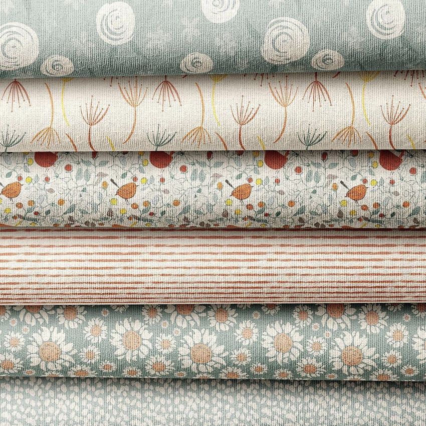 Fabric stack mockup featuring six folded textiles with various patterns, including florals, stripes, birds, and abstract designs.