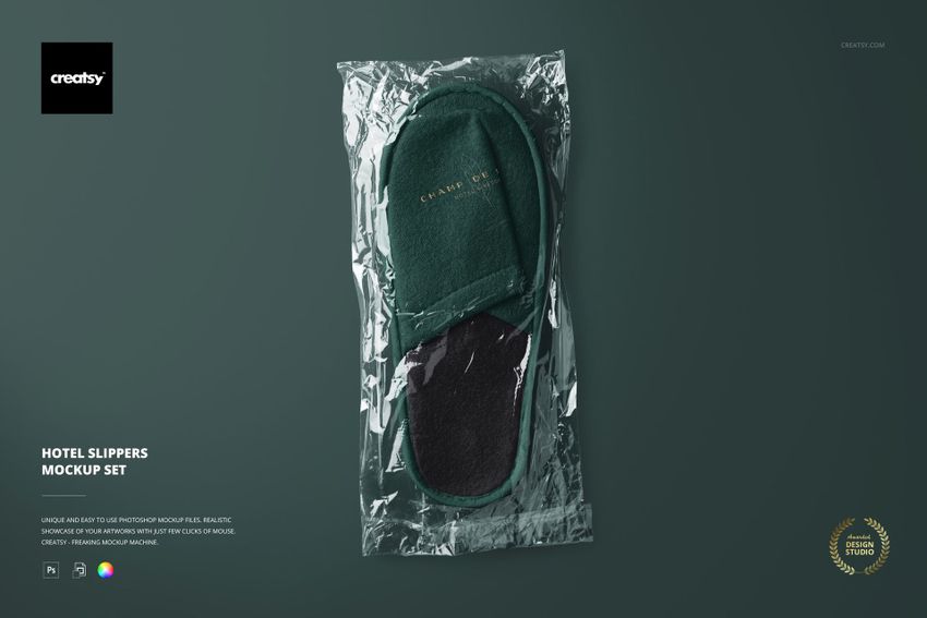 Green hotel slipper mockup in transparent foil packaging, shown from above on a solid dark green surface.