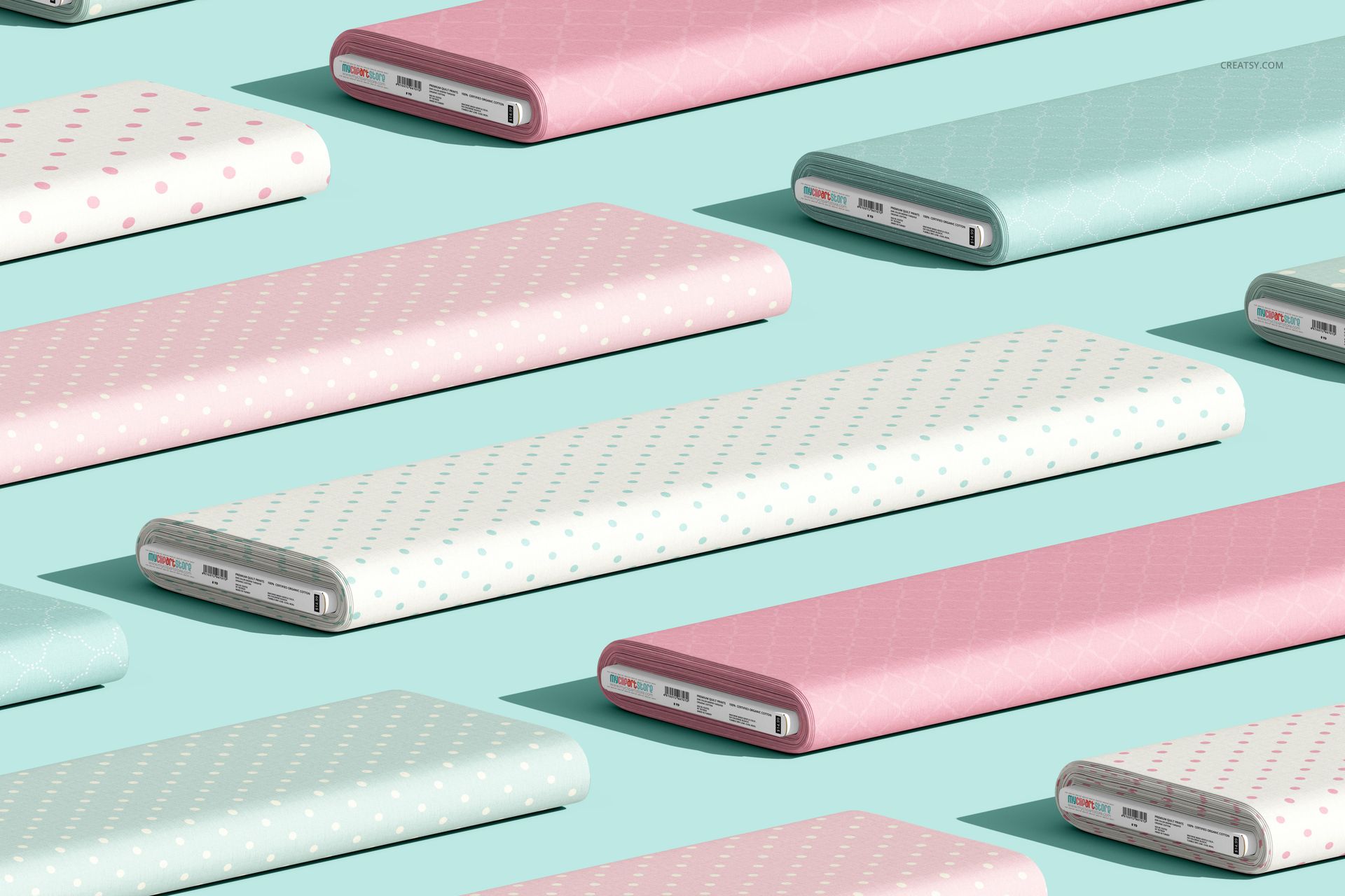 Pastel-colored fabric bolts with polka dot prints, shown from an angled perspective on a light blue tabletop in a mockup scene.