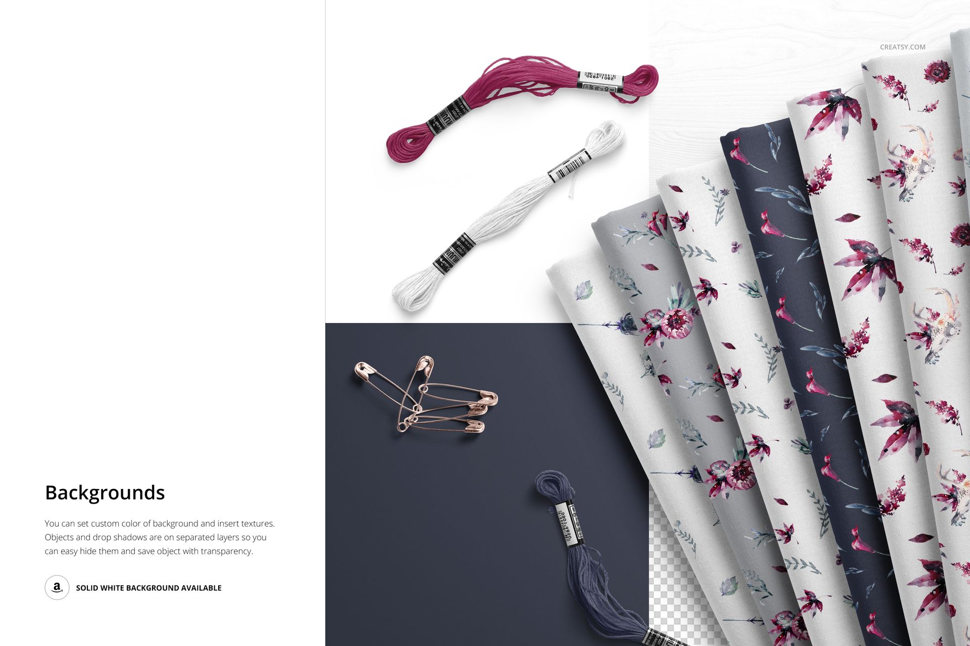 PSD mockup showing folded textiles with assorted botanical prints, embroidery threads, and metal pins from above.