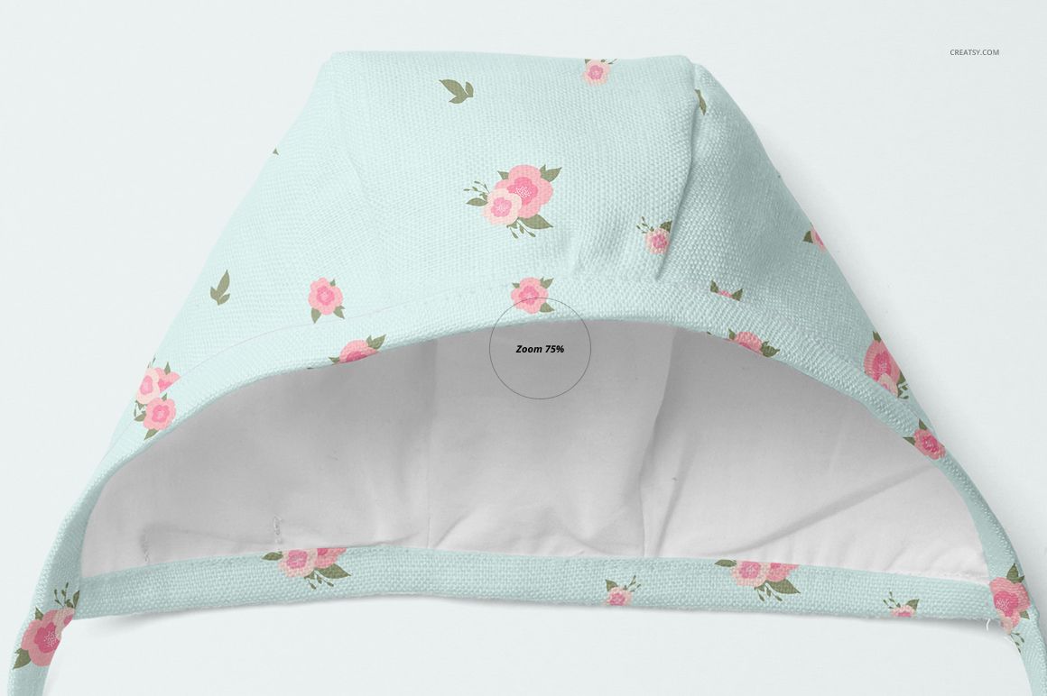 PSD mockup of a baby bonnet featuring a pastel blue fabric with pink flowers, displayed in close-up front view.