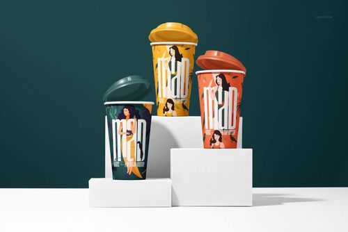 Front view of three paper cup mockups with vibrant artwork and colored lids arranged on geometric white stands.