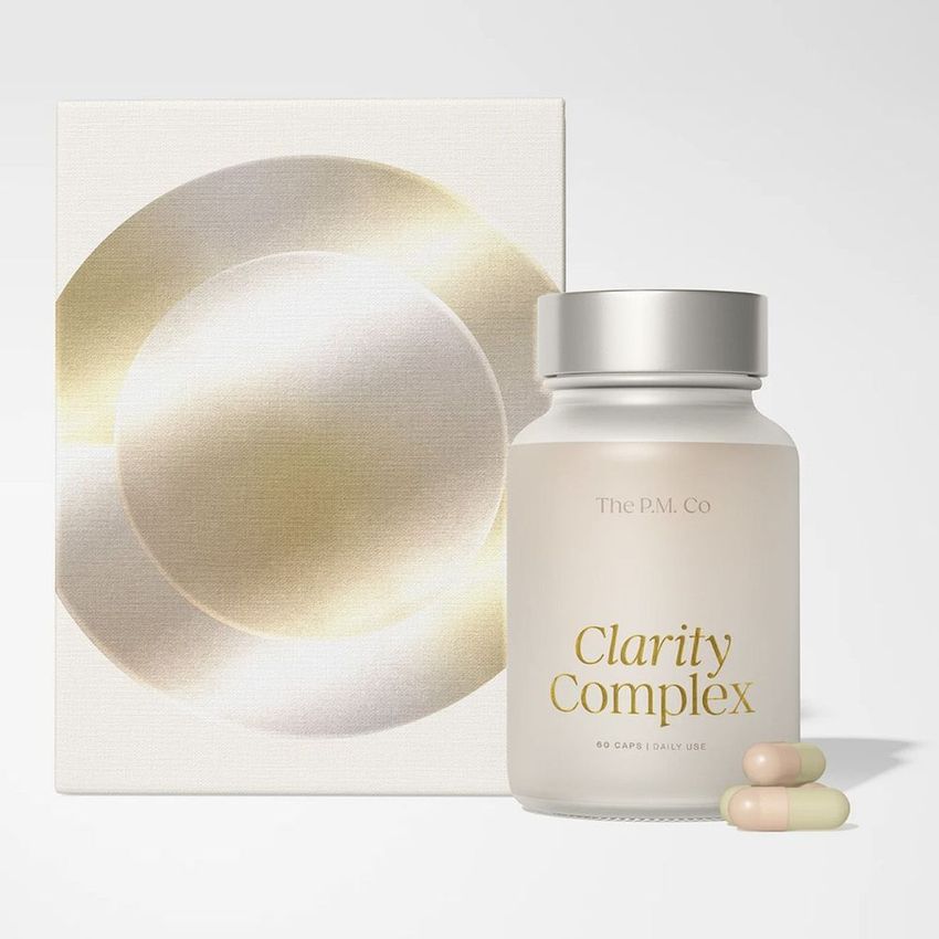 Cosmetics box packaging mockup featuring a glass capsule bottle labeled Clarity Complex, two capsules, and a minimal abstract box.
