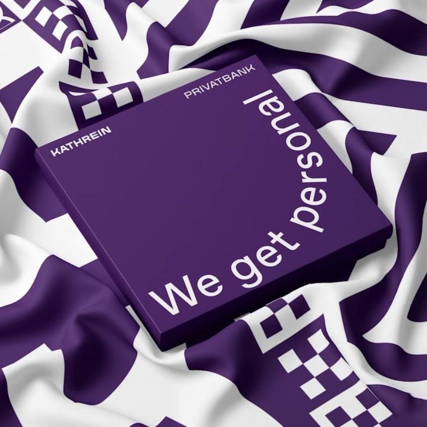 Twill silk scarf mockup featuring a purple box with white text placed on a patterned fabric with geometric designs.
