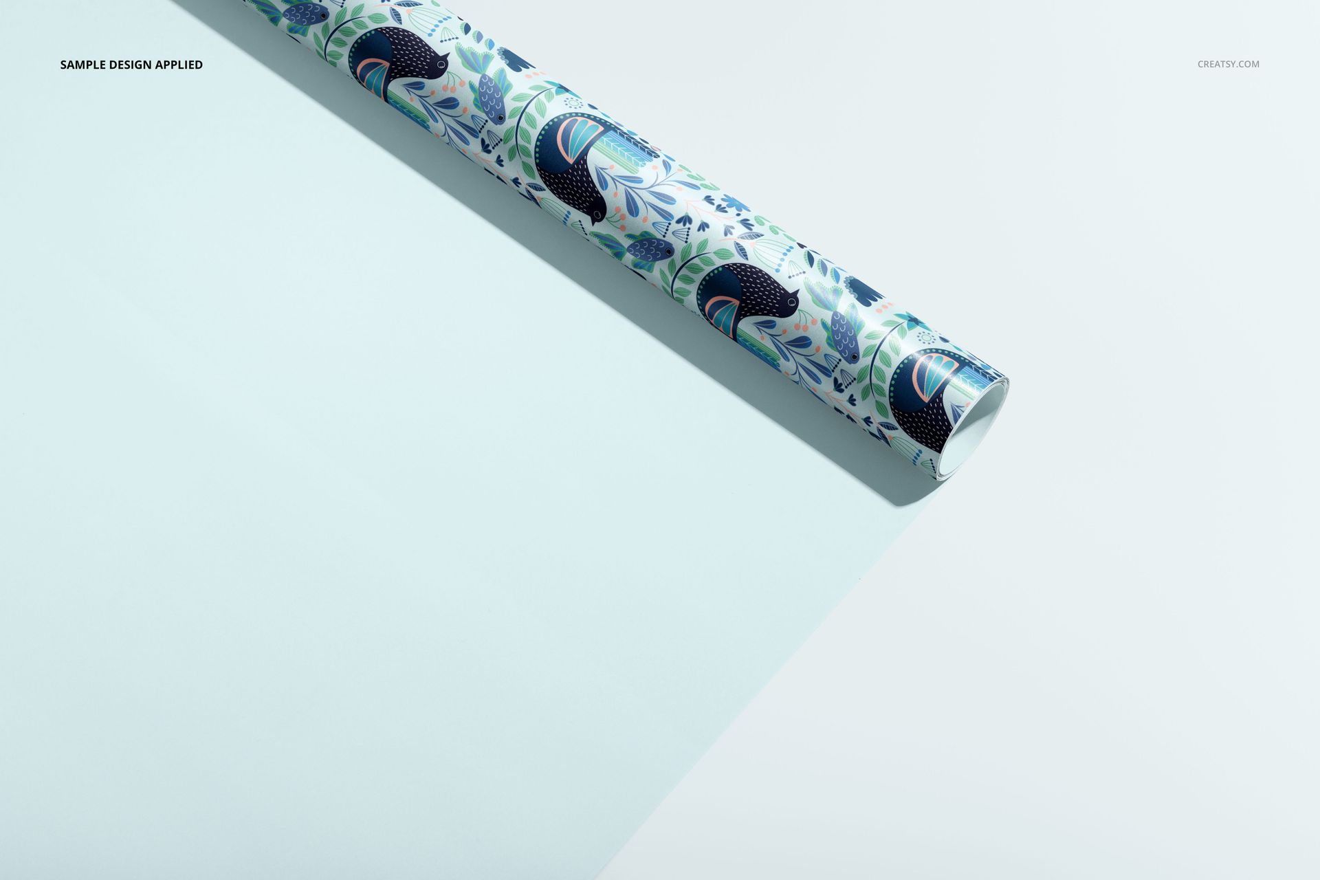 Gift wrapping paper PSD mockup with a vibrant botanical pattern, positioned diagonally on a light tabletop.