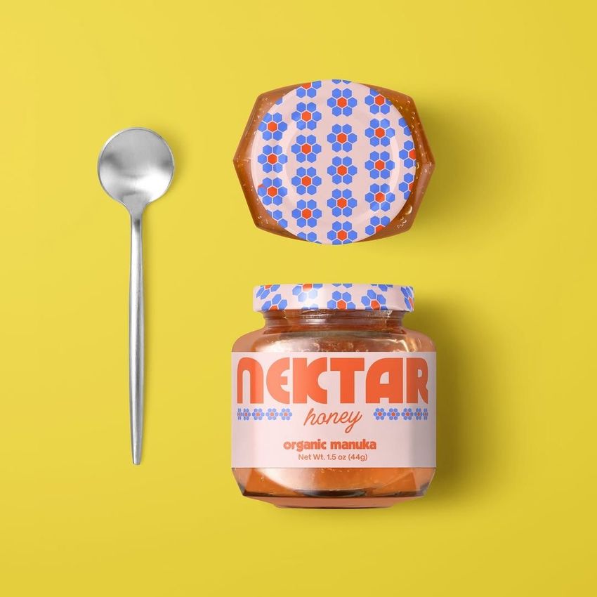 Apricot jam jar mockup with a patterned lid and a colorful label, placed next to a metal spoon on a solid yellow background.