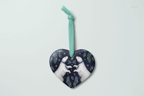 Heart-shaped Christmas ornament mockup featuring two white polar bears and green foliage on a dark background, front view.