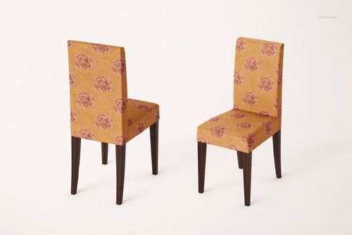Pair of dining chairs with straight backs and dark wood legs, featuring yellow covers with pink flower motifs, shown in a mockup scene.