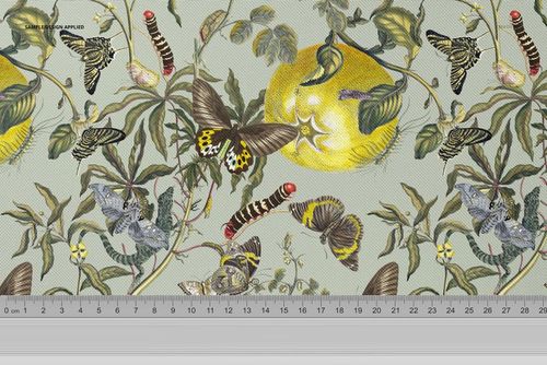 PSD mockup of fabric featuring a detailed nature-inspired design with butterflies, leaves, and a yellow fruit, ruler shown.