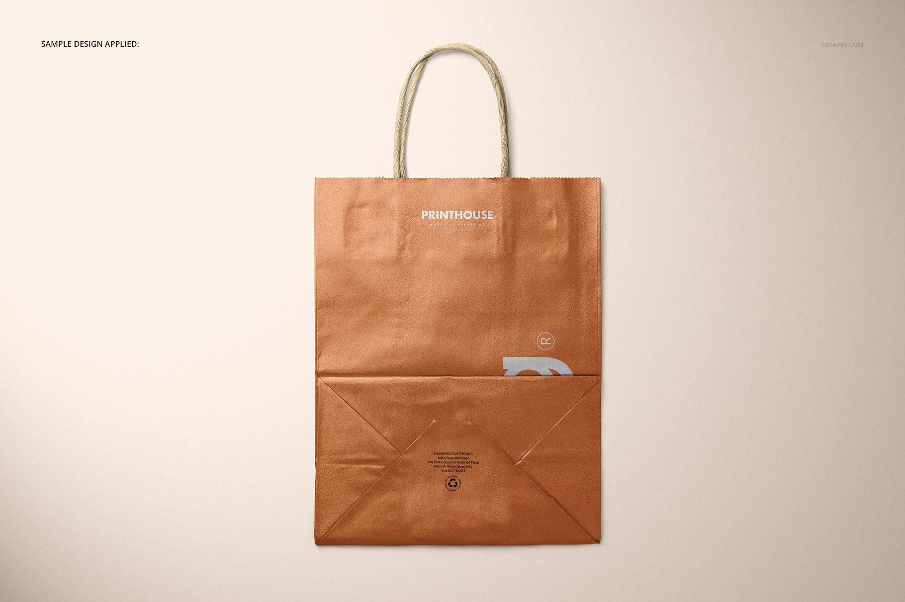 Metallic kraft paper shopping bag mockup shown from above, featuring a copper finish and simple design details.