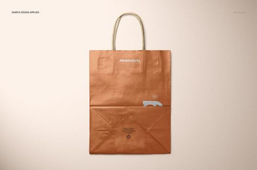 Metallic kraft paper shopping bag mockup shown from above, featuring a copper finish and simple design details.