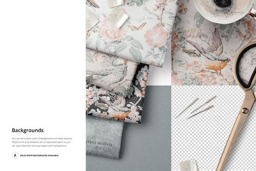 Folded fabric pieces with floral and bird patterns in pastel and dark tones, shown from a top view with sewing props.